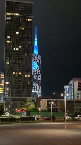 Batumi's lit-up tower and Ferris wheel on a summer night
