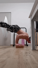 Man performs handstand on wooden block in Burgas