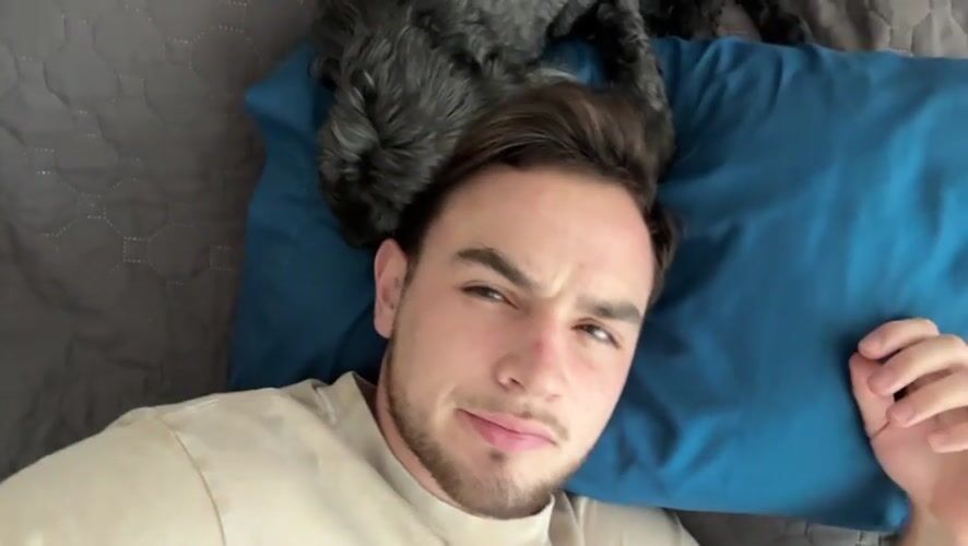 Man rests on bed with small dog in Mexico