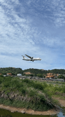 Turboprop aircraft makes landing approach over Thai countryside