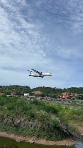 Turboprop aircraft makes landing approach over Thai countryside