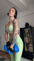 Woman performs morning workout with weights in Generalovo, Bulgaria
