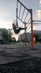 Man exercises on chain pull-up equipment at Burgas park