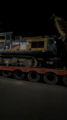 XCMG excavator transported on flatbed trailer in Dhaka