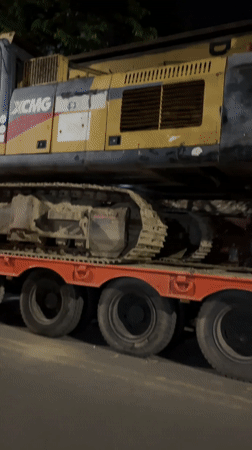 XCMG excavator transported on flatbed trailer in Dhaka