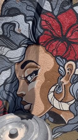 Mural of woman with flower accent documented in Ahangama