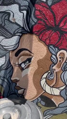 Mural of woman with flower accent documented in Ahangama