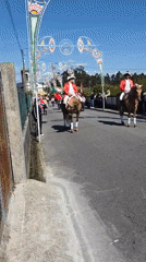 Religious procession with decorated statues proceeds through Barcelos, Portugal