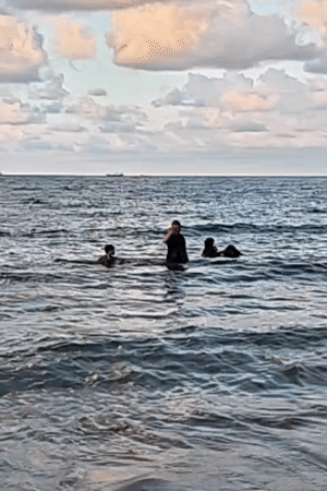 Families enjoy beach day in Lhokseumawe under cloudy skies
