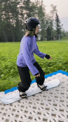 Summer dry-slope snowboarding on a DIY course in Divnogorsk