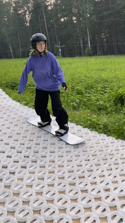 Summer dry-slope snowboarding on a DIY course in Divnogorsk
