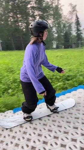 Summer dry-slope snowboarding on a DIY course in Divnogorsk