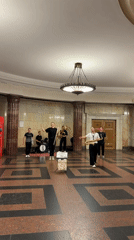 Live band plays Moscow's ornate public interior, surfing mural nearby