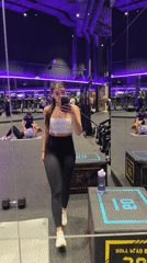 Woman documents gym workout with smartphone selfies in Moscow