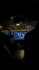 Passenger documents nighttime car ride through Madrid streets