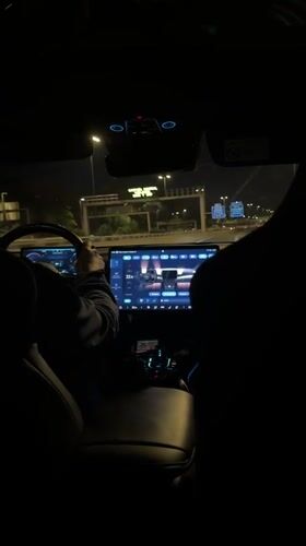 Passenger documents nighttime car ride through Madrid streets