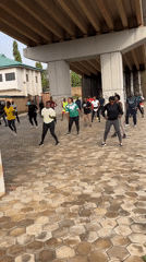 Morning workout crew trains under a Jos overpass