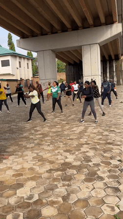 Morning workout crew trains under a Jos overpass
