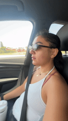 Woman in sunglasses observed in car passenger seat, Cholula
