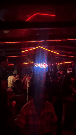 Late-night crowd dances at Abuja nightclub with neon lighting