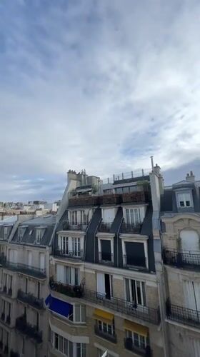 Rooftop panorama across classic Parisian architecture on a cloudy morning