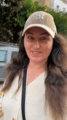 Woman rides electric scooter through Netanya streets in Yankees cap