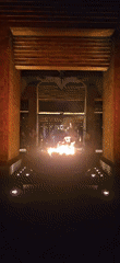Fire pit burns at base of lit stairs in Denpasar