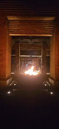 Fire pit burns at base of lit stairs in Denpasar