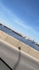 River traffic and cranes observed from bridge in Chaikovsky