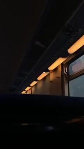 Here is a concise description of the video:

The camera is inside a train car, focusing on the overhead compartment lights. Daylight streams through a window, illuminating the interior slightly. The scene is still, with no apparent movement or action.