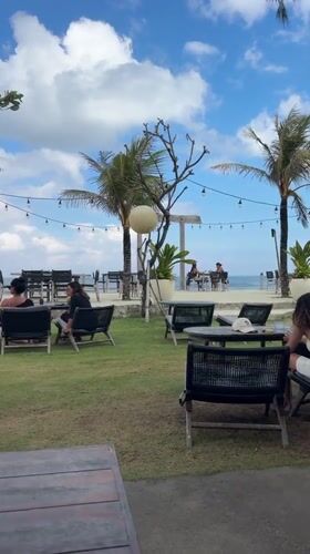 Tourist explores Balinese temples and oceanfront with small dog