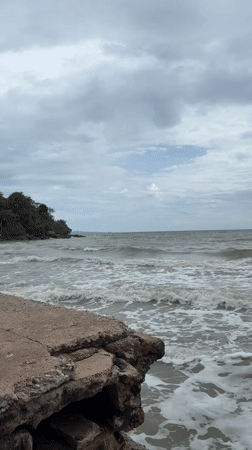 Pattaya's rocky shore on a grey, choppy morning