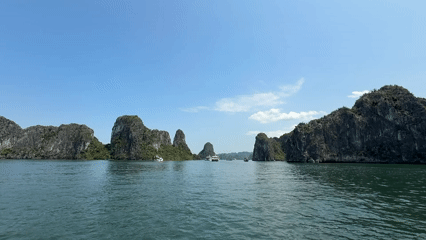 Tourists capture scenic Ha Long Bay views on sunny morning