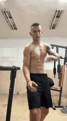 Man poses, winks at camera in home gym