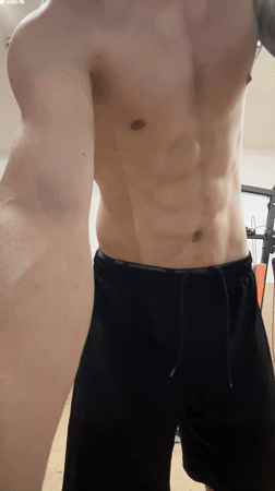 Man poses, winks at camera in home gym