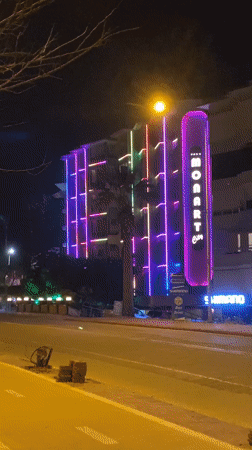 Evening scenes captured around illuminated MONART building in Alanya