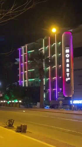 Evening scenes captured around illuminated MONART building in Alanya