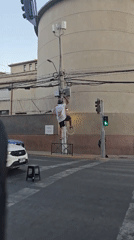 Man hangs white ring on utility pole in Providencia