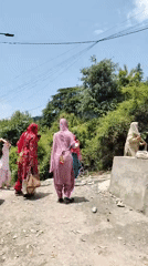 People gather on rural road in Haini, India