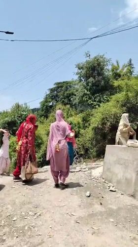 People gather on rural road in Haini, India