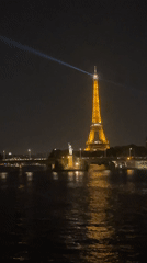 Eiffel Tower glowing at night over the Seine
