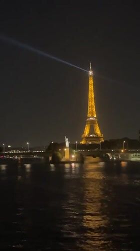 Eiffel Tower glowing at night over the Seine