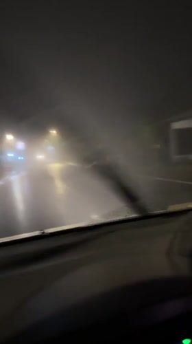 Motorist navigates heavy fog on wet roads in Kintamani