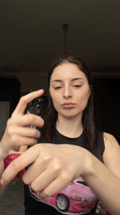 Woman applies makeup in Moscow apartment during afternoon session