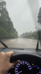 Driver navigates wet roads during heavy rainfall in Thailand