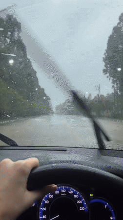 Driver navigates wet roads during heavy rainfall in Thailand