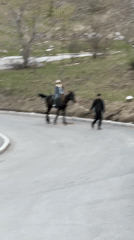 Horseback riders spotted on mountain road near Almaty