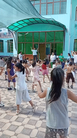 Children's outdoor exercise class at a Fergana City courtyard