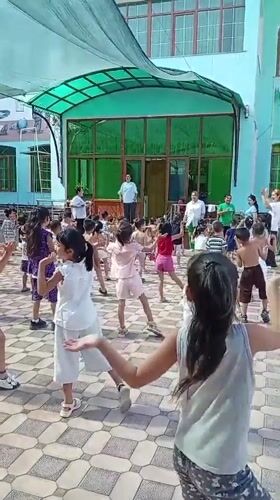 Children's outdoor exercise class at a Fergana City courtyard