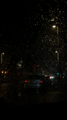 Rainy night scene captured through windshield in Krasnoyarsk